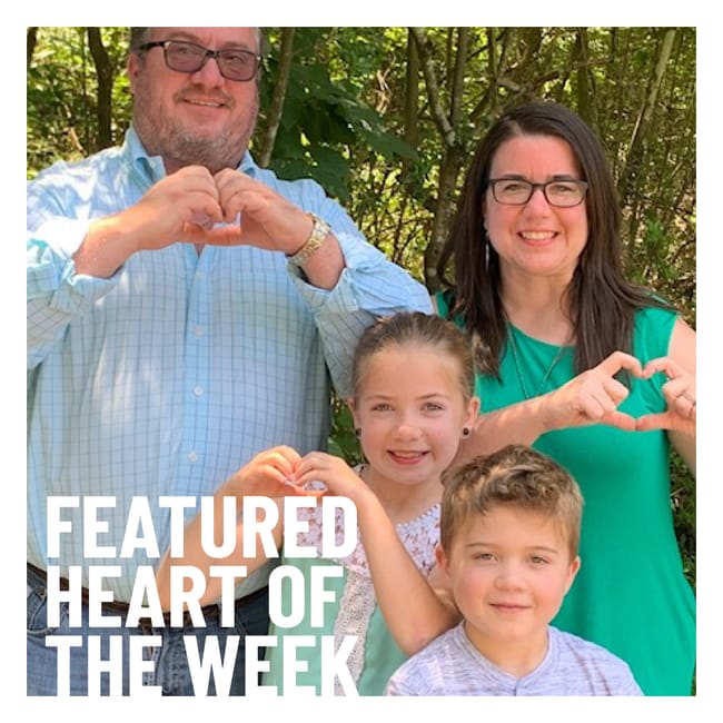 Woman and family make hearts with their hands